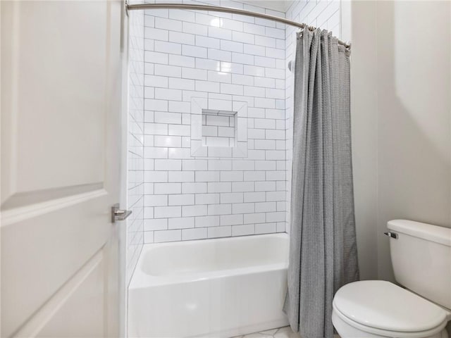 bathroom featuring toilet and shower / bath combo with shower curtain