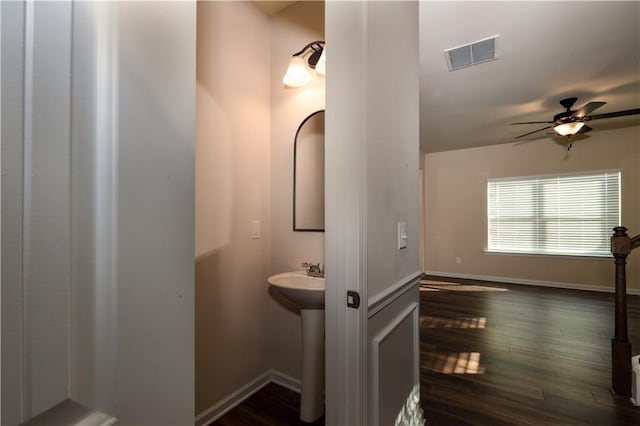 bathroom with hardwood / wood-style flooring and ceiling fan