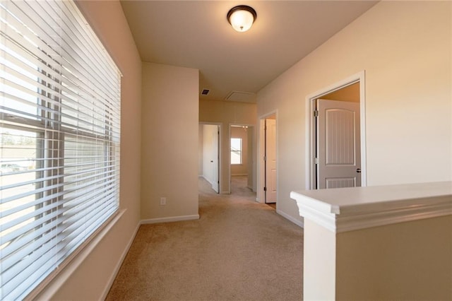 hall with light colored carpet