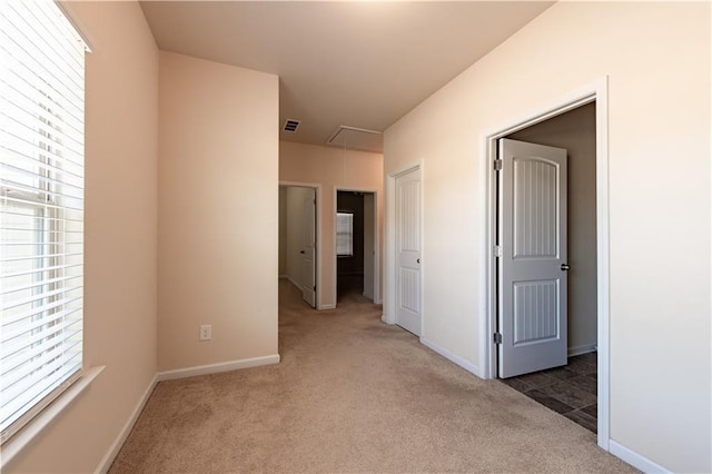 corridor with dark colored carpet