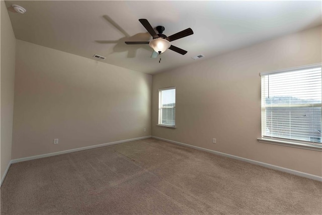 spare room with ceiling fan and carpet floors