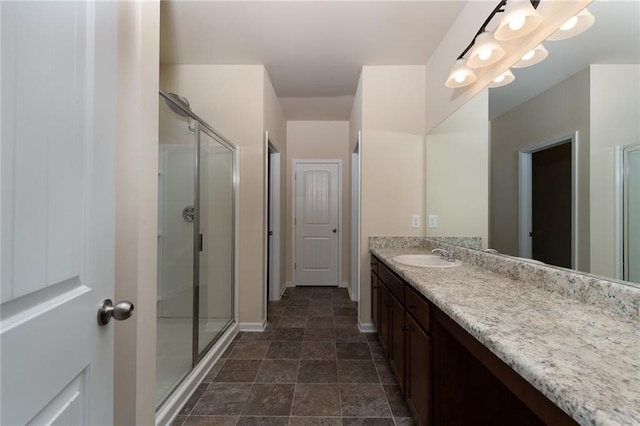 bathroom featuring vanity and an enclosed shower