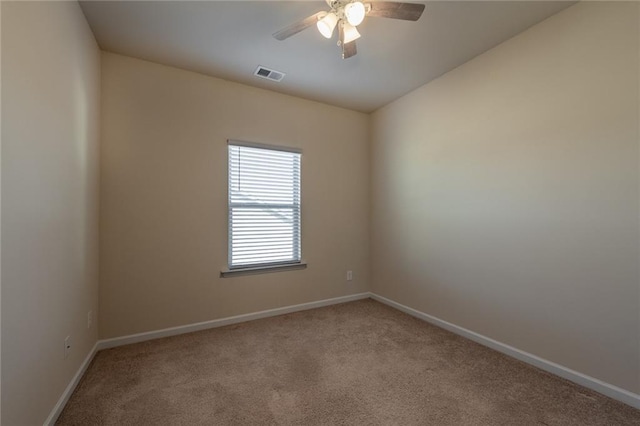 carpeted spare room featuring ceiling fan