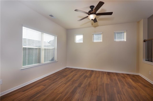 empty room featuring dark hardwood / wood-style flooring and ceiling fan