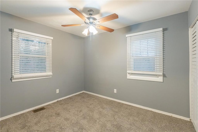 unfurnished room with carpet flooring and ceiling fan