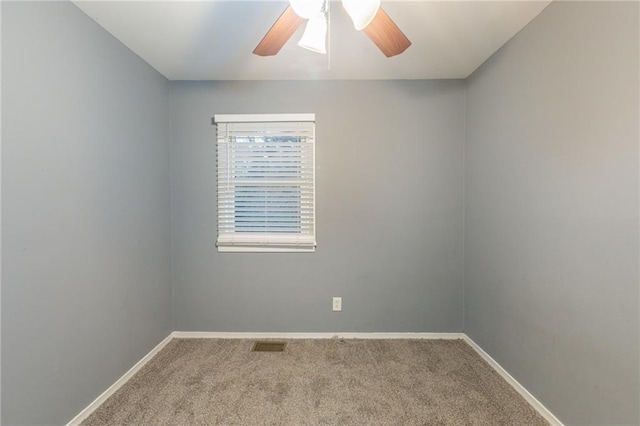 carpeted spare room with ceiling fan