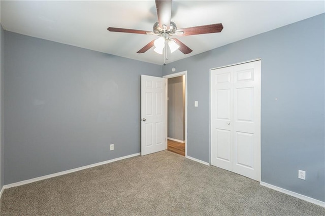 unfurnished bedroom with carpet flooring, ceiling fan, and a closet