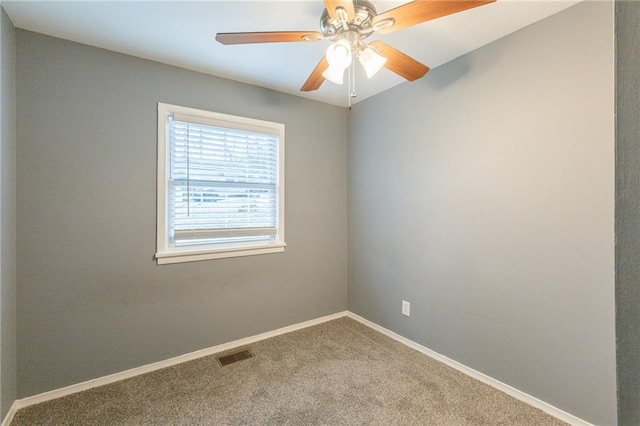 carpeted spare room featuring ceiling fan