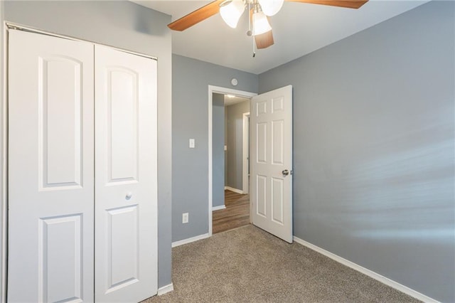 unfurnished bedroom with ceiling fan, light carpet, and a closet