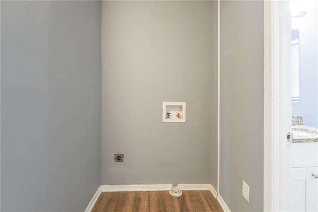 washroom featuring wood-type flooring, washer hookup, and hookup for an electric dryer