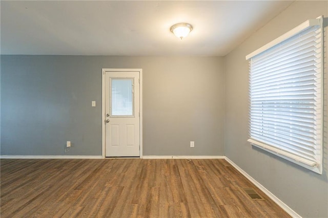 spare room with wood-type flooring