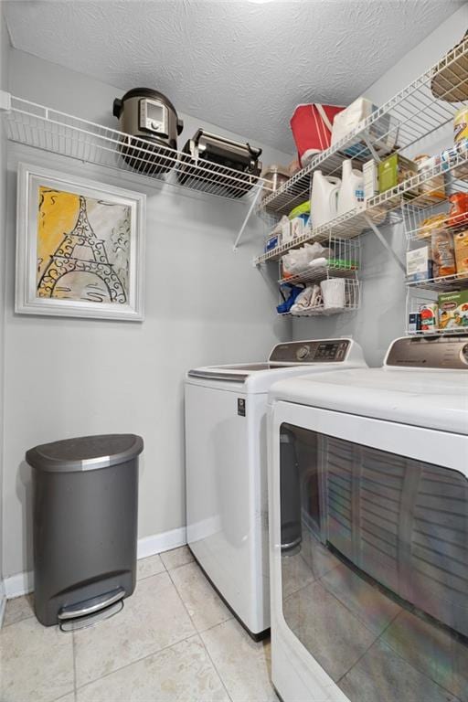 3408 Lake Pointe Cir, Roswell, GA 30075 - washroom with washer and clothes dryer, light tile patterned floors, and a textured ceiling