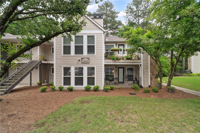 3408 Lake Pointe Cir, Roswell, GA 30075 - view of front of property with stairs, a front lawn, a balcony, and a chimney