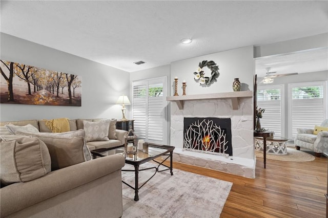 3408 Lake Pointe Cir, Roswell, GA 30075 - living room featuring wood finished floors, healthy amount of natural light, a fireplace, and a ceiling fan