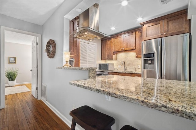 3408 Lake Pointe Cir, Roswell, GA 30075 - kitchen featuring wall chimney exhaust hood, stainless steel refrigerator with ice dispenser, dark wood-type flooring, tasteful backsplash, and light stone countertops