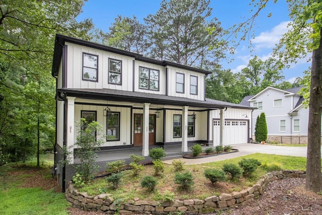 2638 Clairmont Rd, Atlanta, GA 30329 - view of front facade with board and batten siding, covered porch, concrete driveway, and a garage