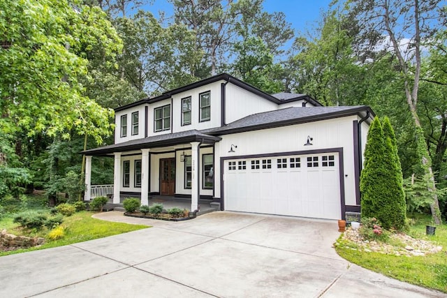 2638 Clairmont Rd, Atlanta, GA 30329 - view of front facade featuring covered porch, a garage, and concrete driveway