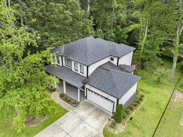 2638 Clairmont Rd, Atlanta, GA 30329 - view of front of property with a porch, concrete driveway, a garage, board and batten siding, and a front yard