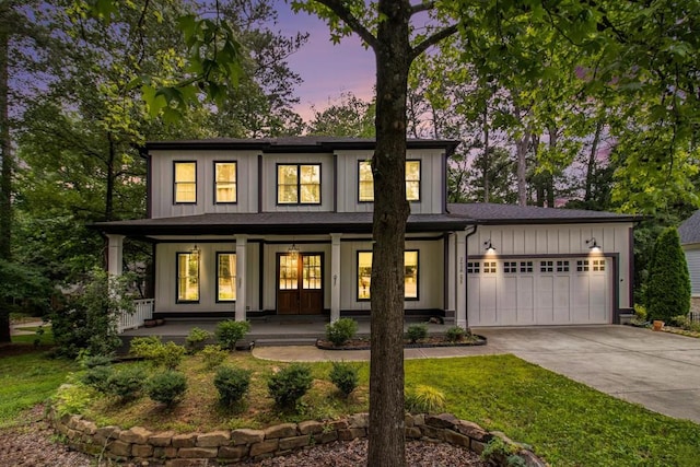 2638 Clairmont Rd, Atlanta, GA 30329 - view of front of house with a porch, driveway, a garage, board and batten siding, and a yard