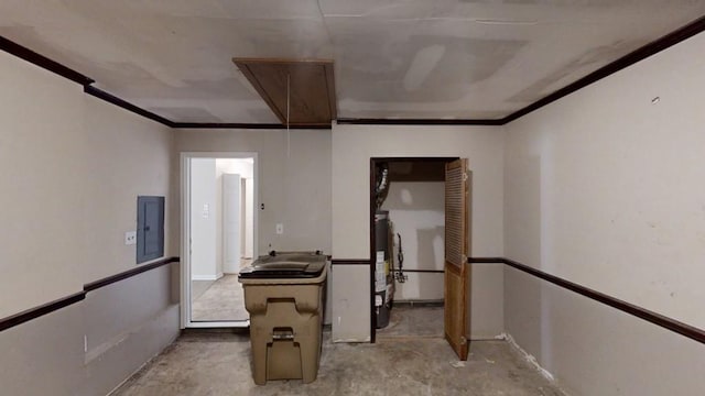corridor featuring attic access, water heater, electric panel, ornamental molding, and unfinished concrete flooring