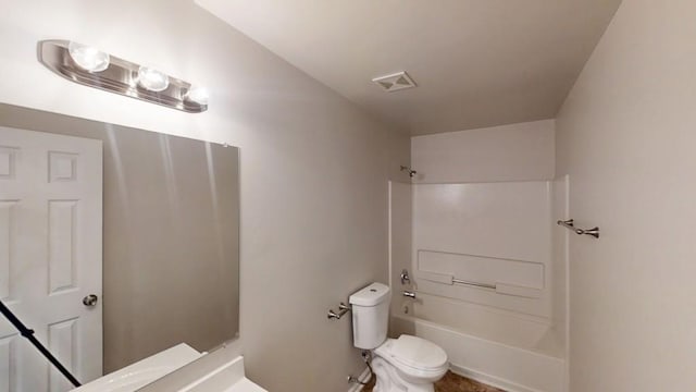 bathroom featuring toilet and shower / bath combination