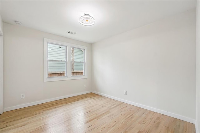 spare room with light hardwood / wood-style flooring