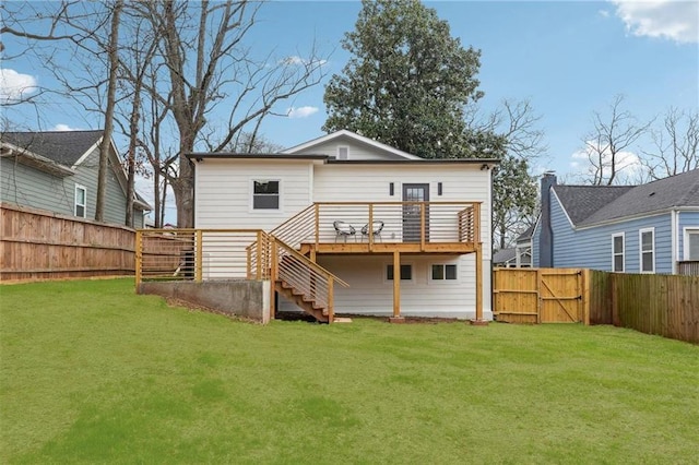 rear view of property featuring a wooden deck and a yard