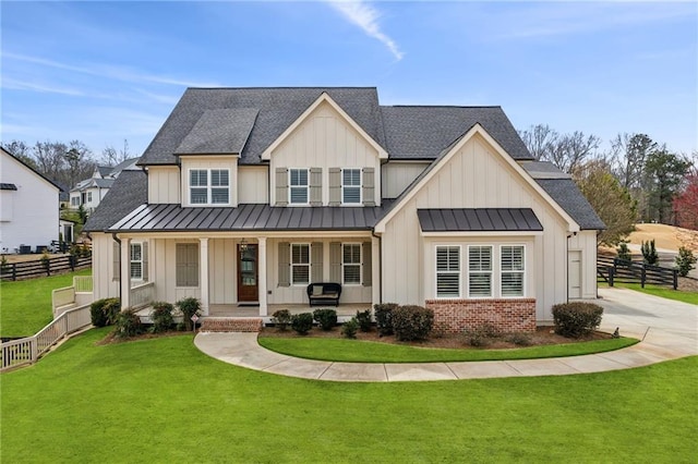 modern inspired farmhouse featuring a standing seam roof, covered porch, board and batten siding, and brick siding