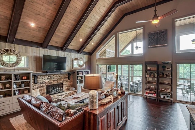 living room featuring wood ceiling, beam ceiling, a stone fireplace, and high vaulted ceiling