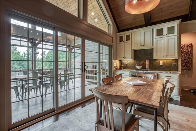 dining area featuring wood ceiling, lofted ceiling, and light hardwood / wood-style floors