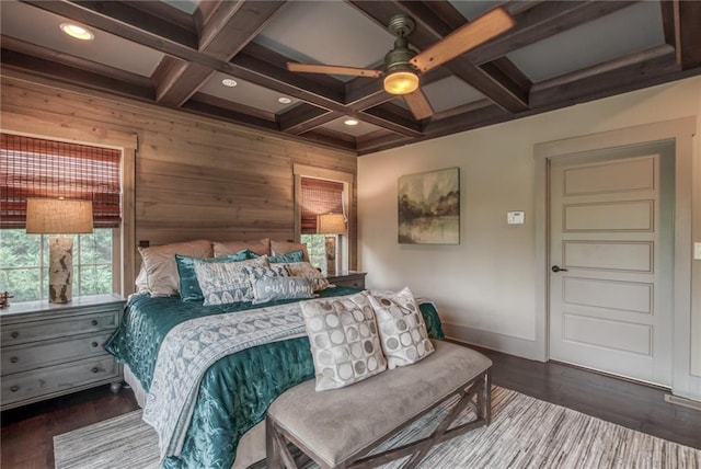 bedroom with coffered ceiling, multiple windows, beam ceiling, and dark hardwood / wood-style flooring