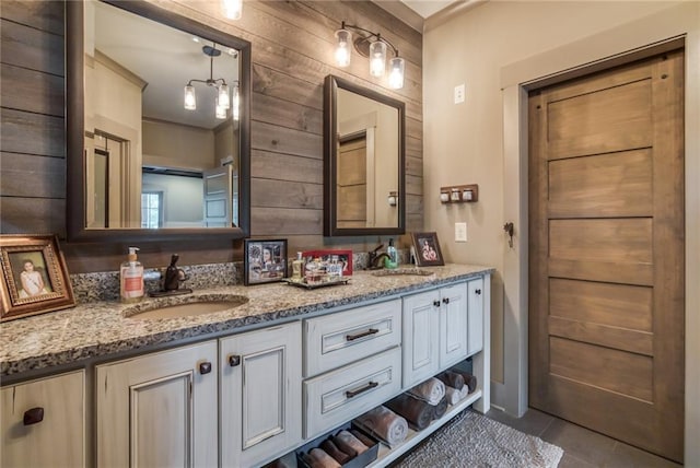 bathroom with dual bowl vanity and tile flooring