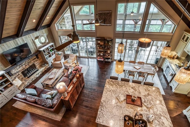 living room with beamed ceiling, ceiling fan, dark hardwood / wood-style flooring, high vaulted ceiling, and wood ceiling