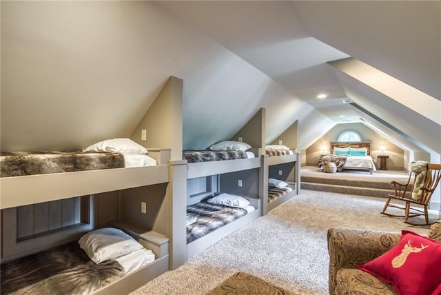 bedroom with carpet floors and vaulted ceiling