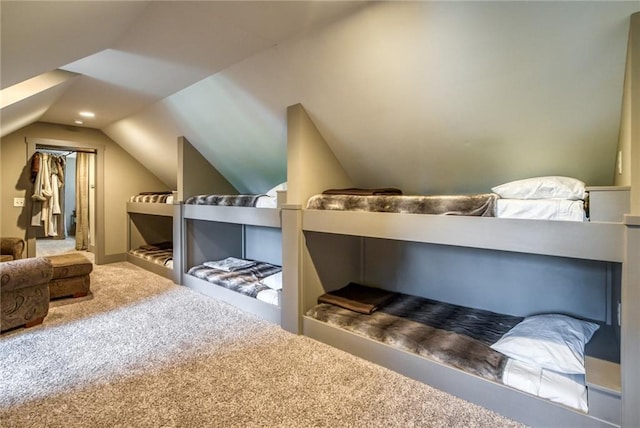 bedroom featuring lofted ceiling and carpet flooring