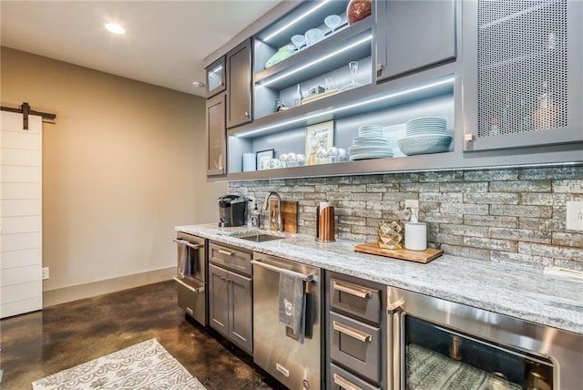 bar featuring a barn door, wine cooler, sink, dishwasher, and light stone counters