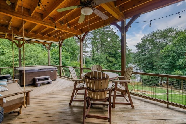 deck with ceiling fan and a hot tub