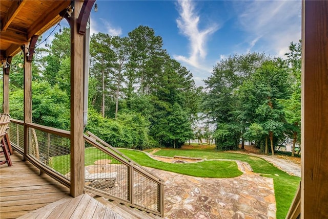 wooden deck featuring a yard