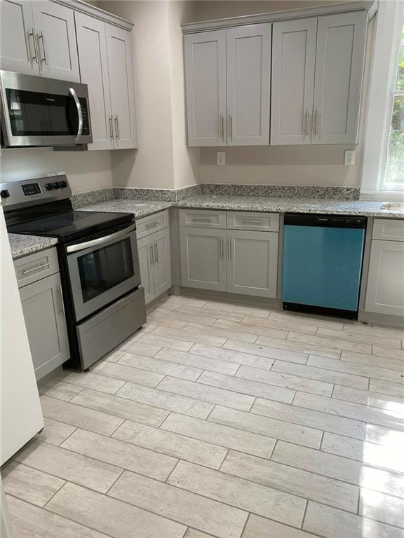 kitchen with gray cabinetry and stainless steel appliances