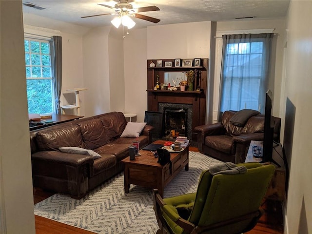 living room featuring hardwood / wood-style floors and ceiling fan