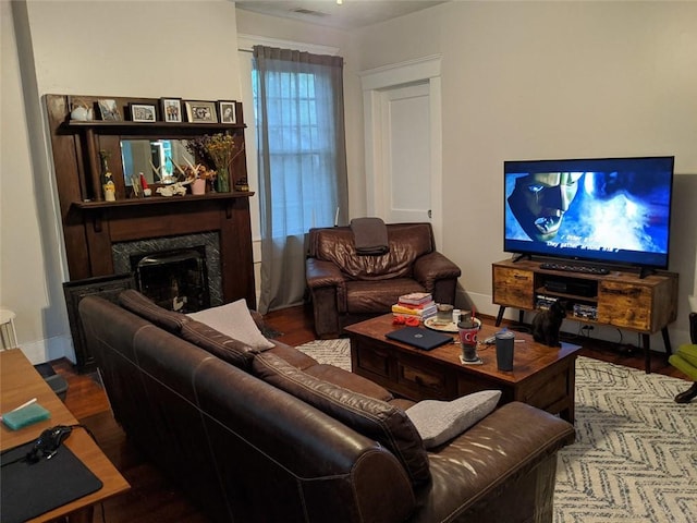 living room featuring hardwood / wood-style flooring and a high end fireplace