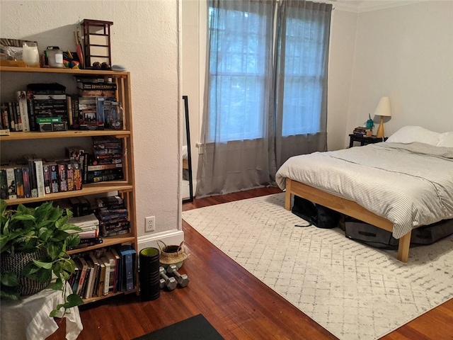 bedroom with hardwood / wood-style floors