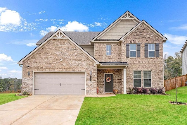 craftsman-style home featuring a front yard, concrete driveway, brick siding, and an attached garage