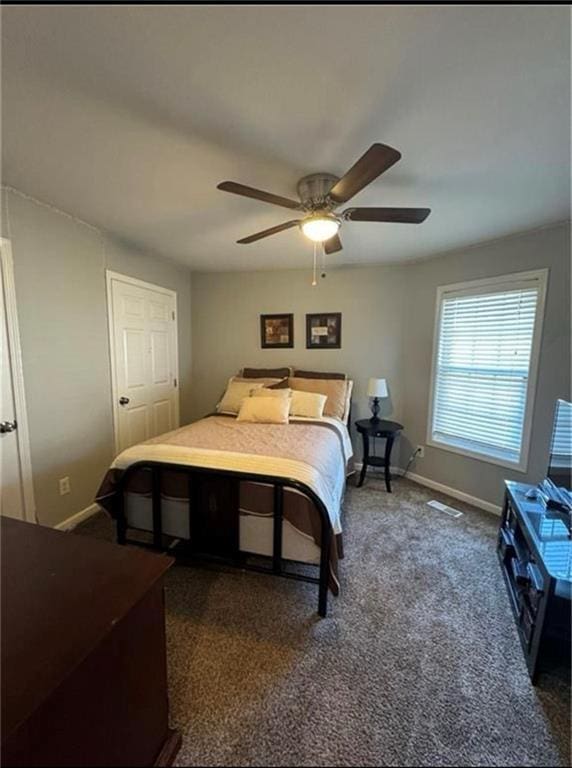 carpeted bedroom featuring a closet and ceiling fan