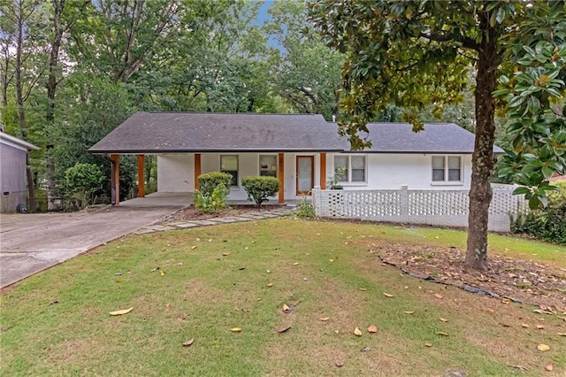 ranch-style house featuring a front lawn, covered porch, and a carport