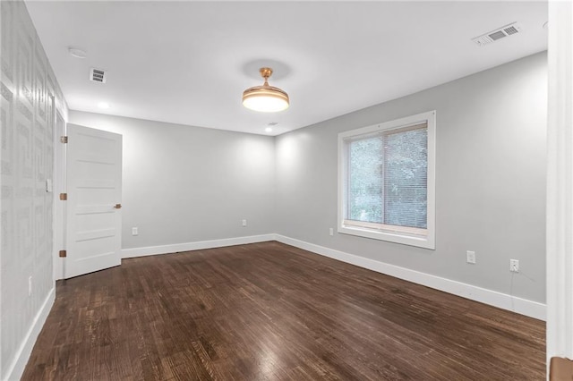 spare room featuring dark hardwood / wood-style floors