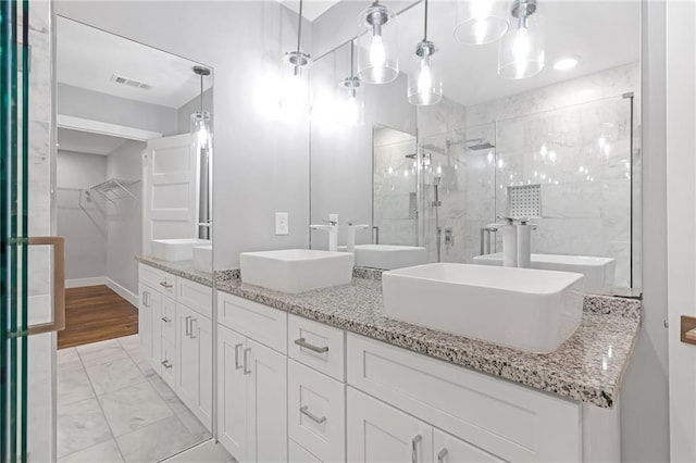 bathroom featuring vanity and a shower with shower door