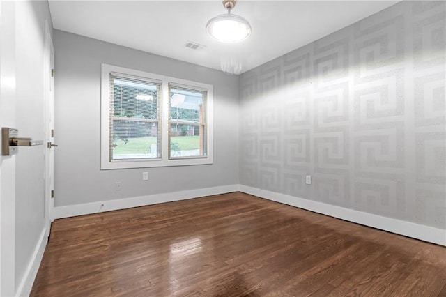 spare room with dark hardwood / wood-style floors