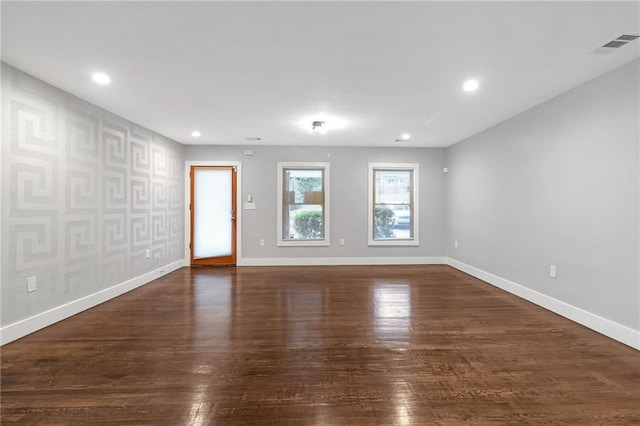 spare room with dark hardwood / wood-style floors