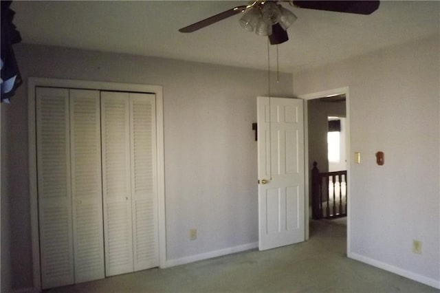 unfurnished bedroom featuring carpet flooring, ceiling fan, and a closet